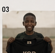 Child holding a KOD tee